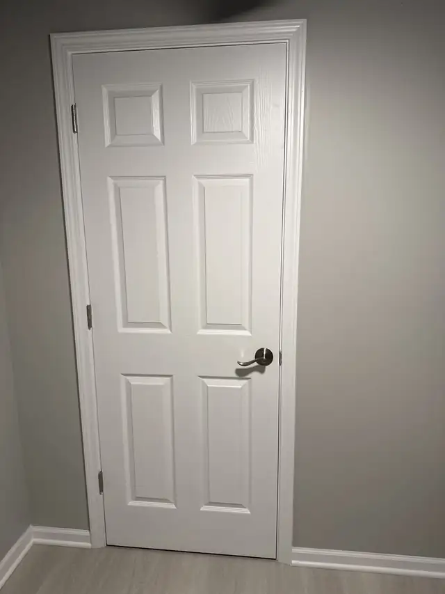 New white six-panel interior door with a silver lever handle